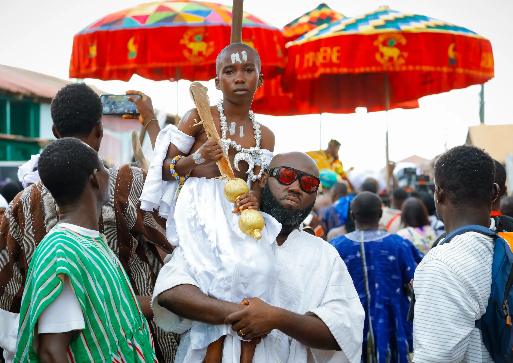 Ohene Okra is pictured carried on a man’s shoulder